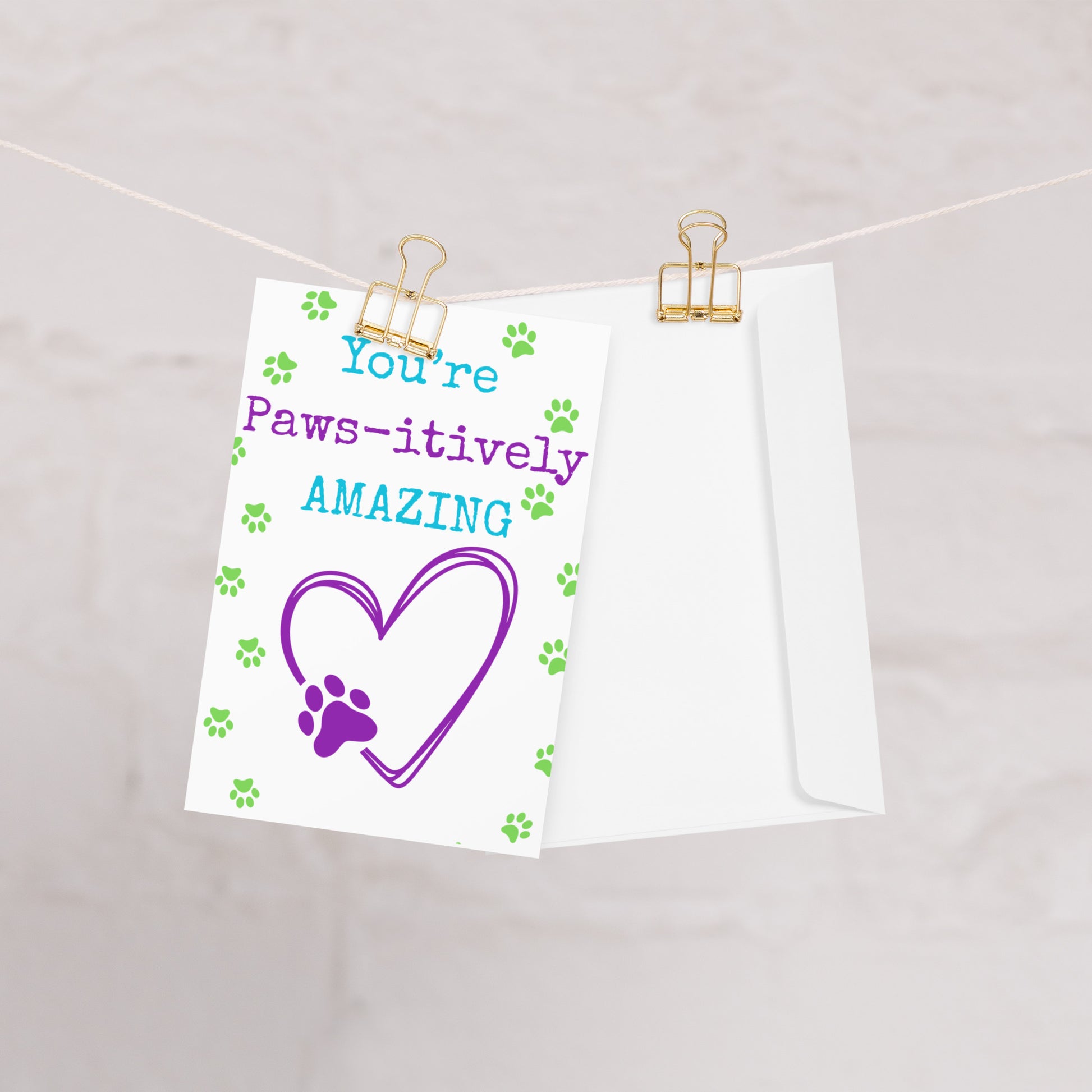 Note with 'You're Paws-itively Amazing' text and heart design on a white background