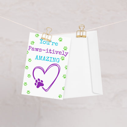 Note with 'You're Paws-itively Amazing' text and heart design on a white background