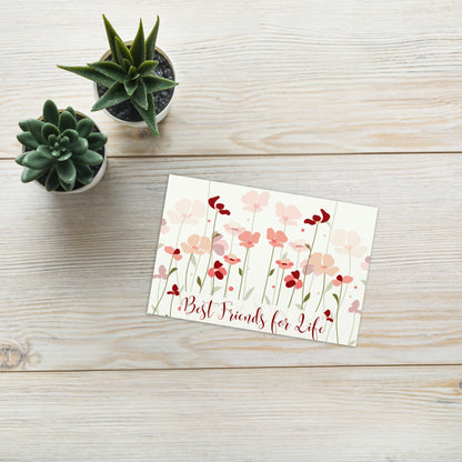 Floral card with 'Best Friends for Life' text on a wooden surface with small potted plants.