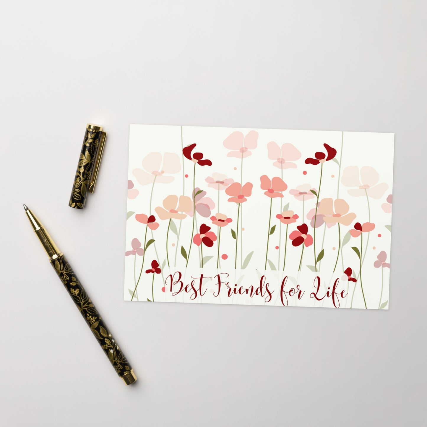 Floral card with 'Best Friends for Life' text and decorative pen on a light gray background