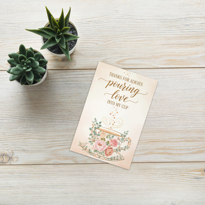 Greeting card with floral design and text on a wooden surface with potted plants.