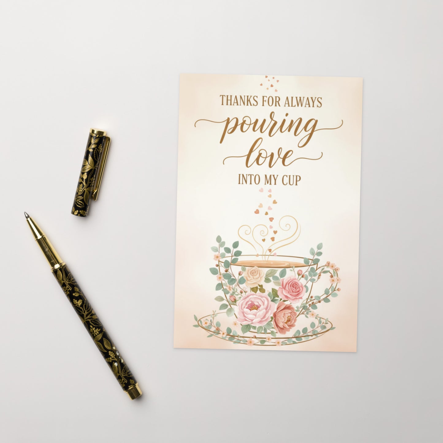 Greeting card with floral design and pen on a light gray background