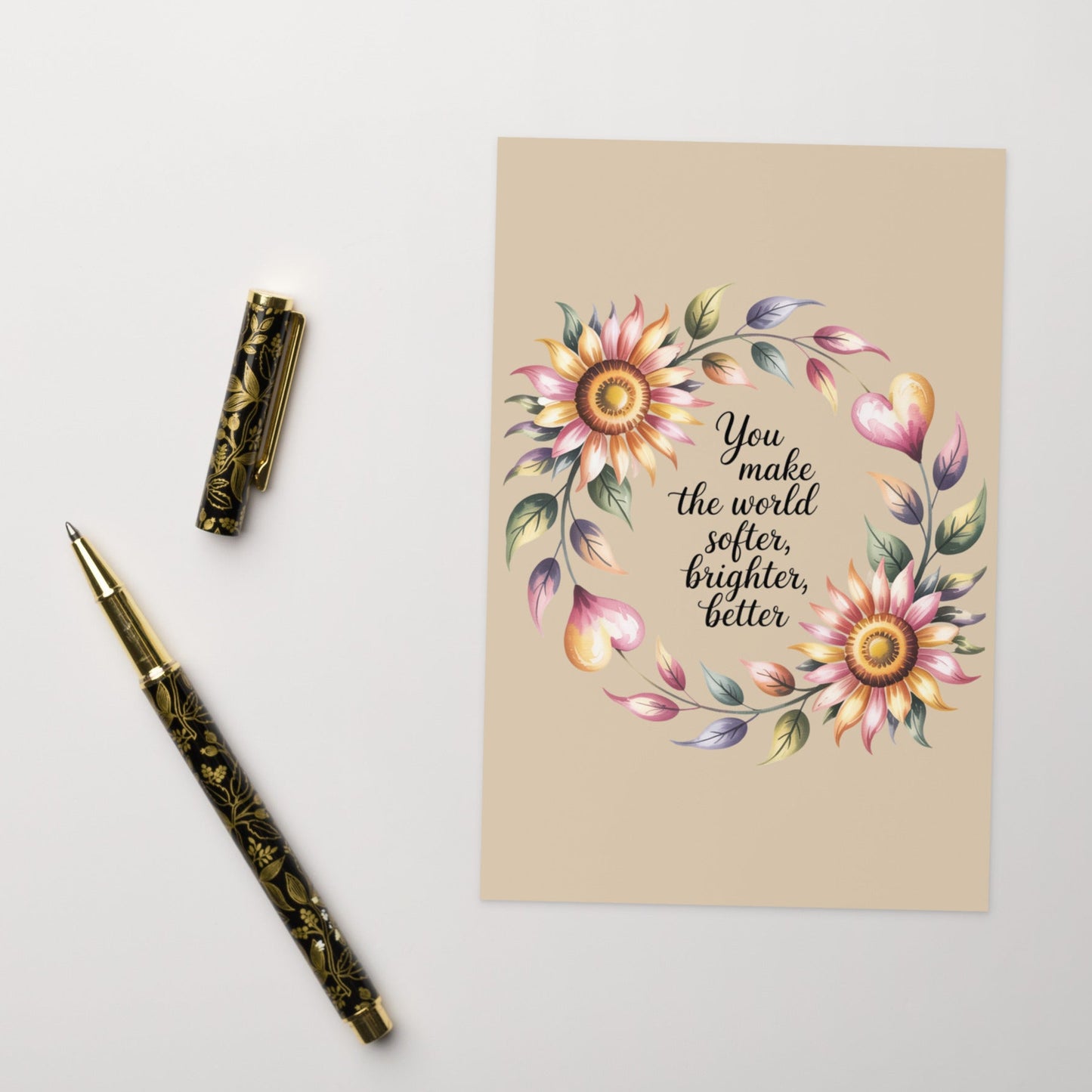 Floral design postcard with motivational quote on a beige background, accompanied by decorative pen and ink bottle.